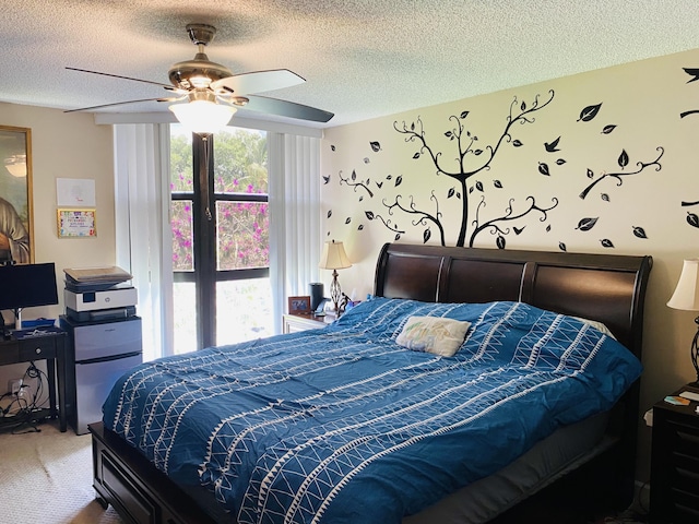 carpeted bedroom featuring ceiling fan and a textured ceiling