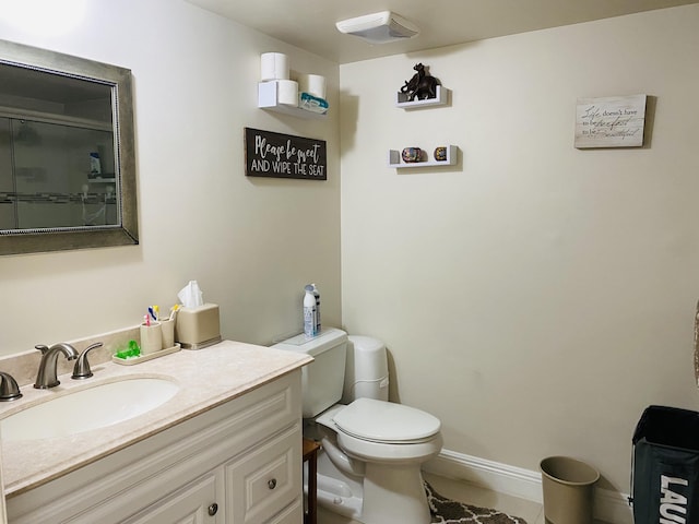 bathroom featuring tile patterned floors, vanity, and toilet