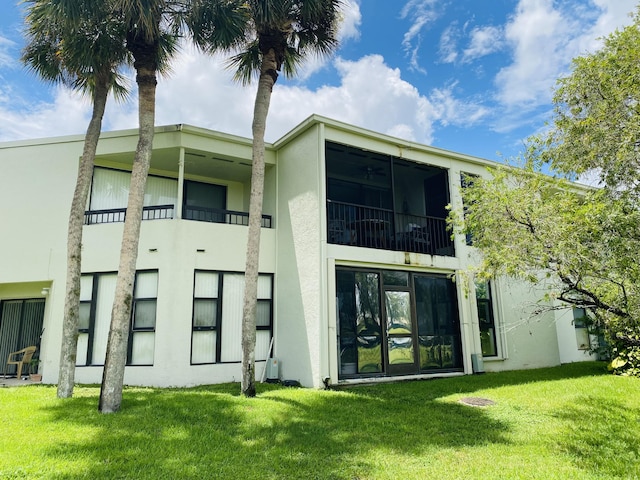 rear view of property featuring a yard