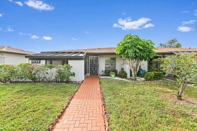 ranch-style home featuring a front yard