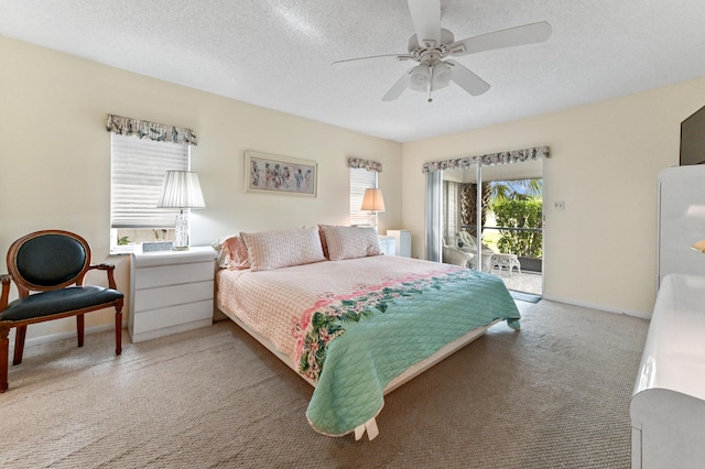 carpeted bedroom featuring access to exterior, ceiling fan, and a textured ceiling