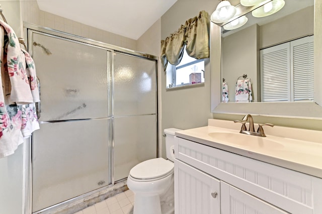 bathroom featuring tile patterned floors, vanity, toilet, and walk in shower