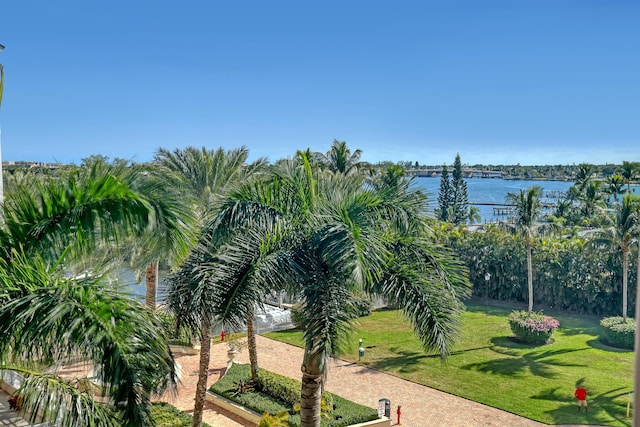 view of home's community featuring a water view and a yard