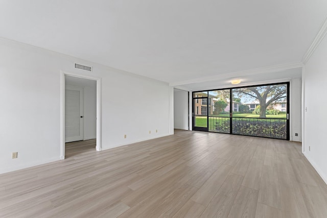 spare room with light hardwood / wood-style floors and expansive windows