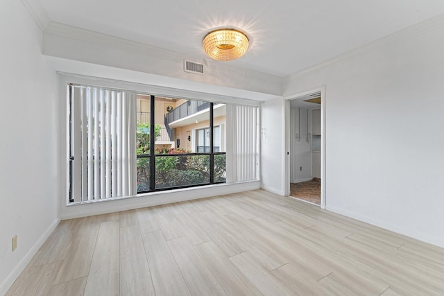 unfurnished room with light wood-type flooring and ornamental molding