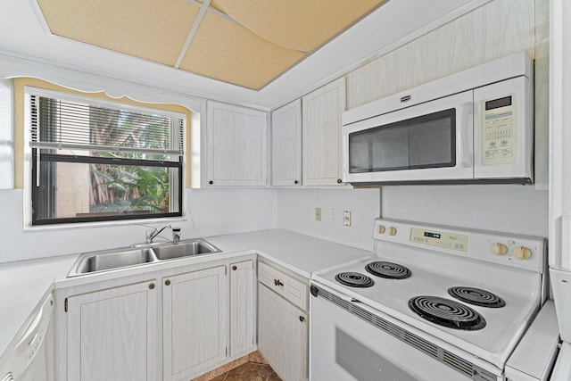 kitchen with tile patterned floors, sink, and white appliances