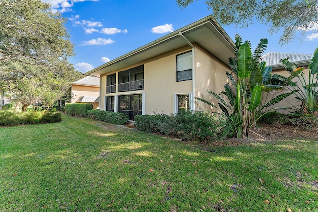 view of side of home featuring a lawn