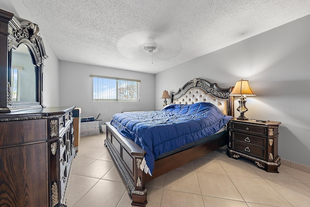 tiled bedroom with a textured ceiling and ceiling fan