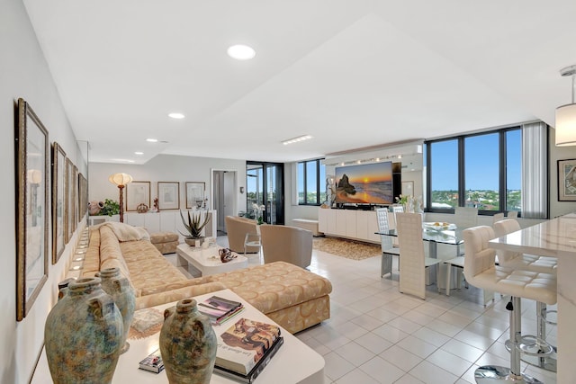 tiled living area with a wall of windows and recessed lighting