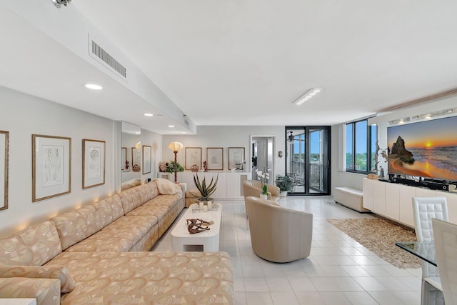 living area featuring recessed lighting, visible vents, and light tile patterned floors