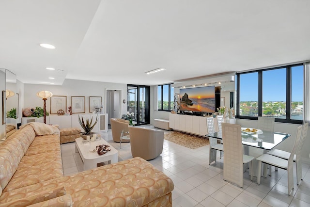 living area with light tile patterned floors, floor to ceiling windows, and recessed lighting