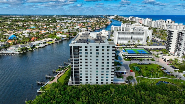 birds eye view of property with a water view and a city view