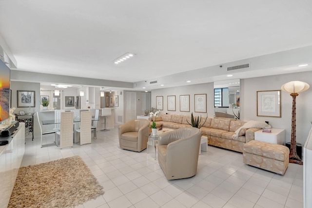 living room with recessed lighting, visible vents, and light tile patterned flooring