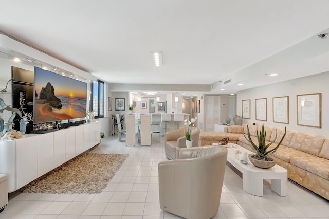 living room featuring light tile patterned floors, visible vents, and recessed lighting