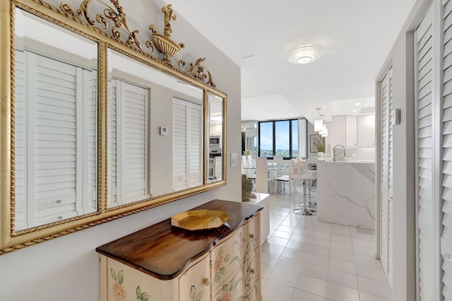 interior space featuring light tile patterned floors and a sink