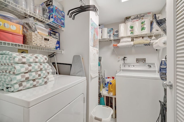 clothes washing area with washer and dryer and laundry area