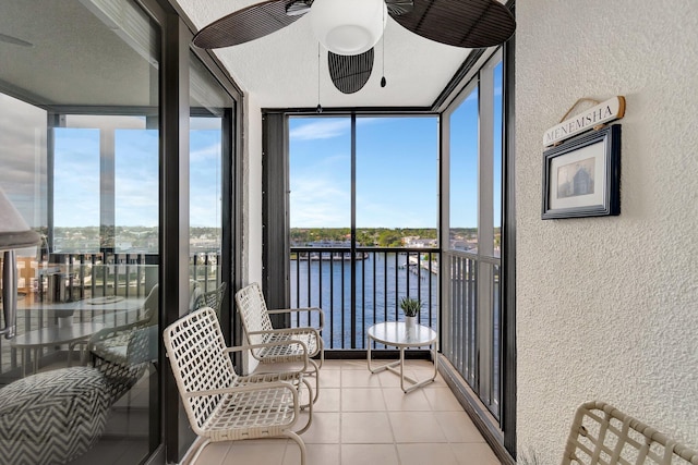 sunroom / solarium featuring a water view