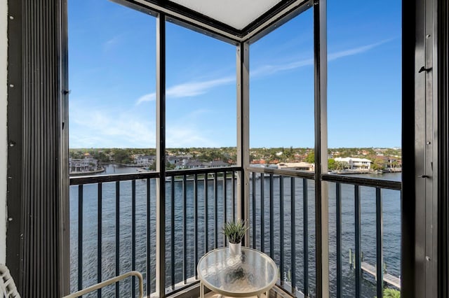 unfurnished sunroom with plenty of natural light and a water view