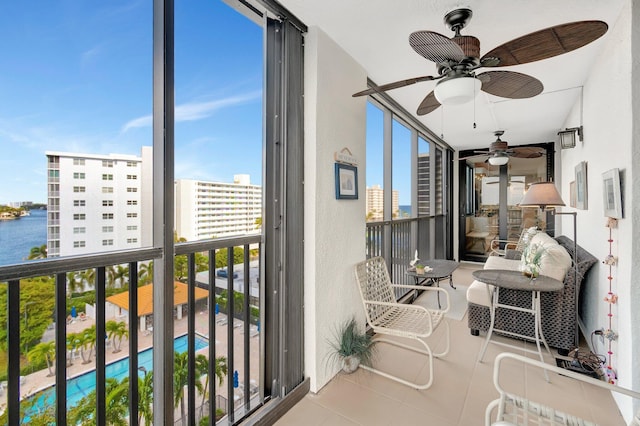 balcony with a view of city and ceiling fan