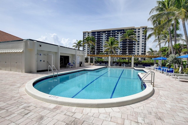 community pool with a patio area