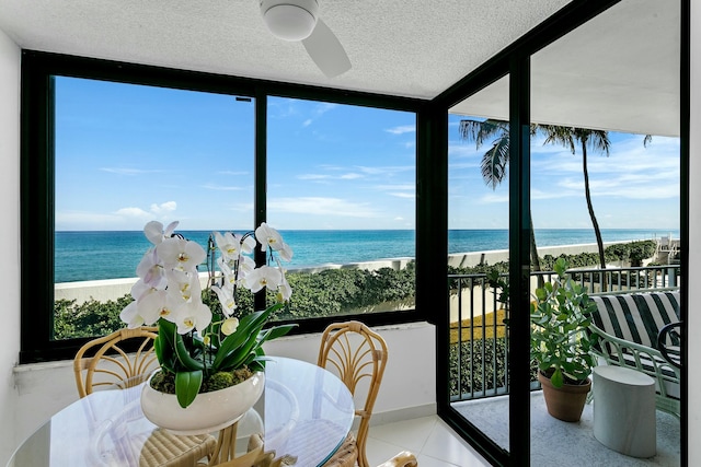 sunroom / solarium featuring plenty of natural light and a water view