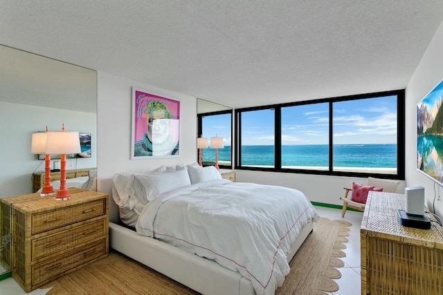 tiled bedroom with a textured ceiling