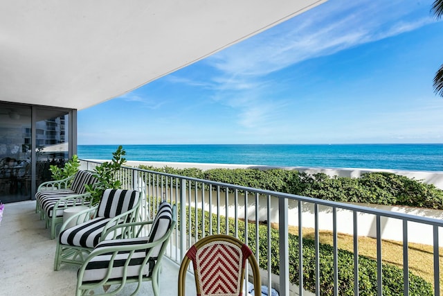 balcony with a view of the beach and a water view