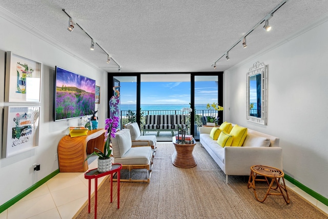 living room featuring a textured ceiling, floor to ceiling windows, crown molding, and rail lighting