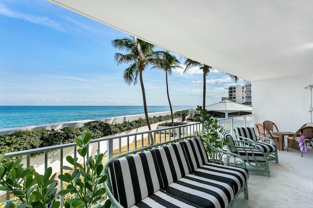 balcony with a water view and a beach view