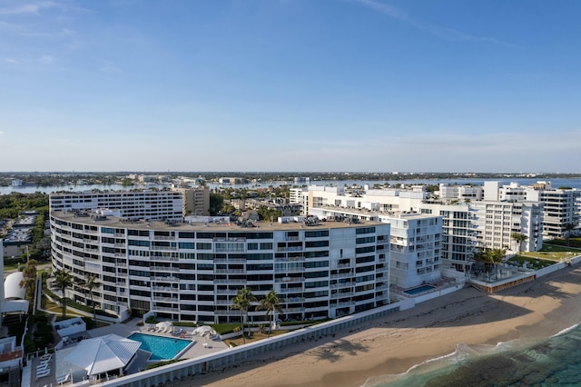 birds eye view of property with a view of the beach and a water view