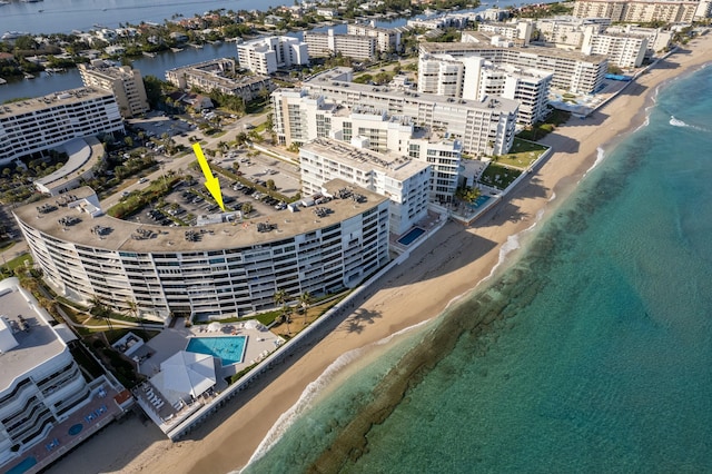 bird's eye view featuring a water view and a beach view