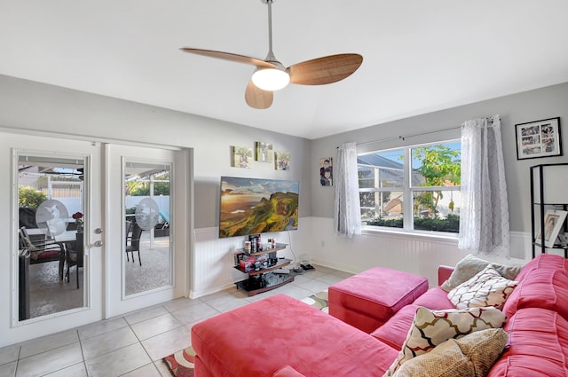 living room with ceiling fan, french doors, light tile patterned floors, and a healthy amount of sunlight