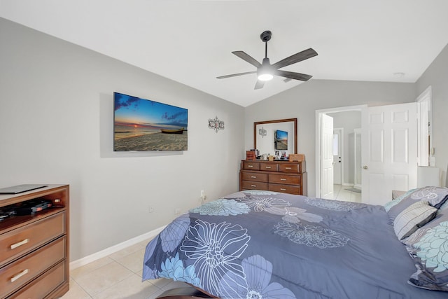 bedroom with connected bathroom, ceiling fan, light tile patterned floors, and vaulted ceiling