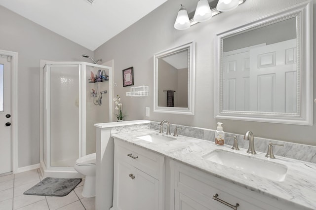 bathroom with tile patterned floors, vaulted ceiling, toilet, a shower with door, and vanity