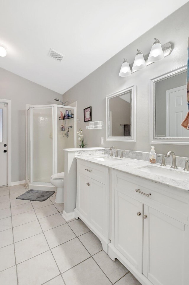 bathroom featuring tile patterned flooring, vaulted ceiling, toilet, vanity, and a shower with shower door