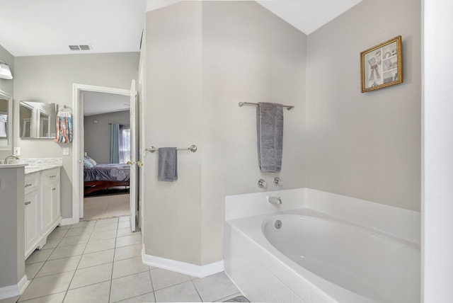 bathroom with tile patterned floors, tiled bath, vanity, and vaulted ceiling