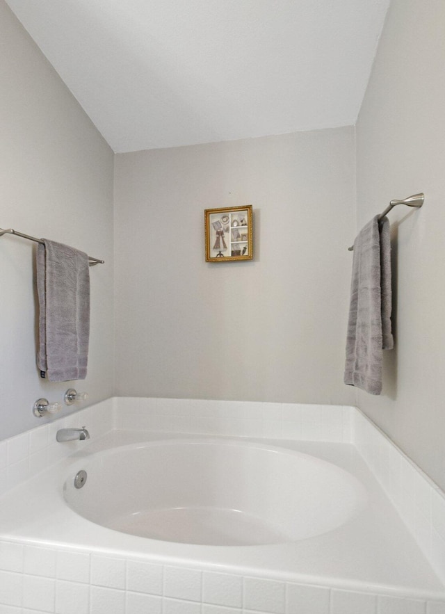 bathroom with tiled bath