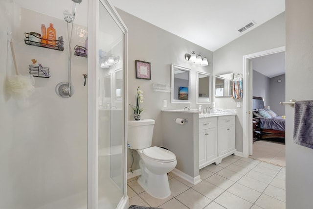 bathroom featuring vanity, vaulted ceiling, tile patterned floors, and toilet