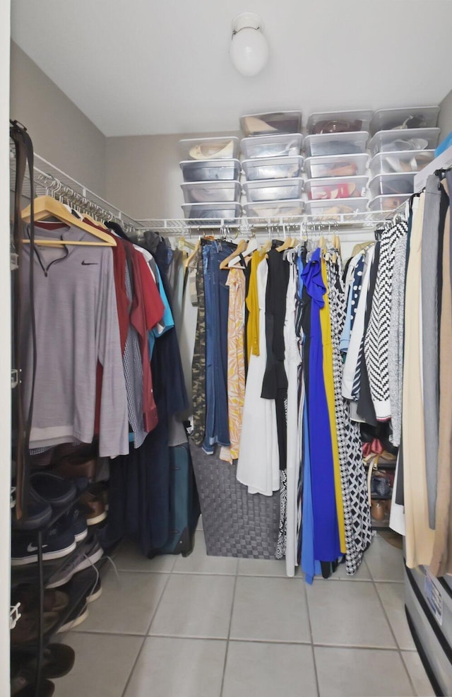 walk in closet with tile patterned floors