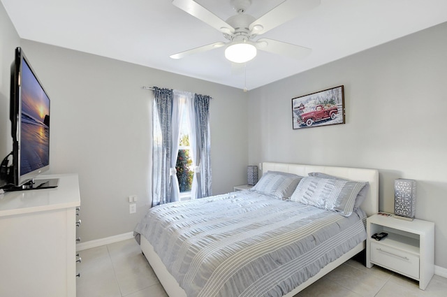 tiled bedroom featuring ceiling fan