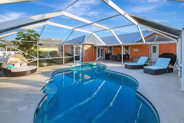 view of swimming pool with a lanai and a patio