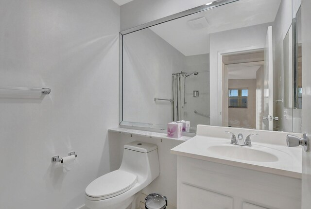 bathroom featuring walk in shower, vanity, and toilet