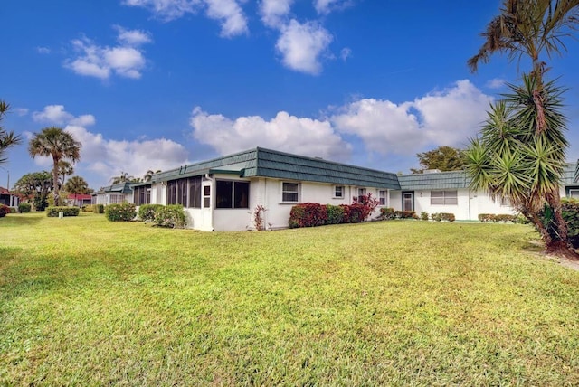 view of side of home with a lawn