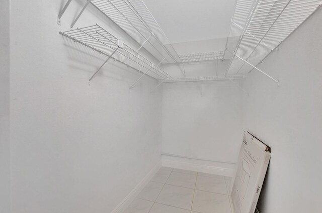 spacious closet with light tile patterned floors