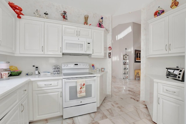 kitchen with white cabinets and white appliances