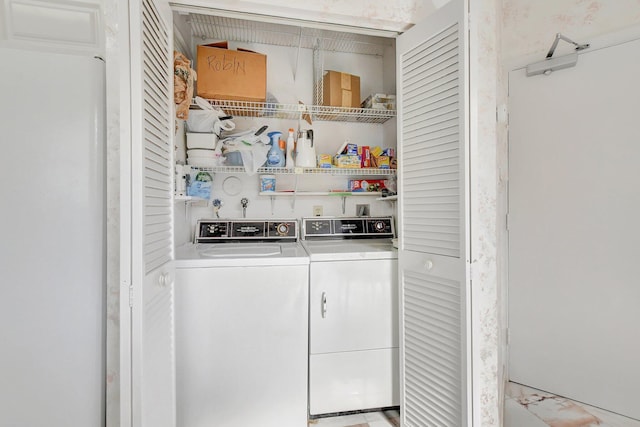 clothes washing area with washing machine and dryer