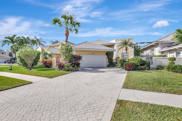 view of front of home with a garage and a front lawn