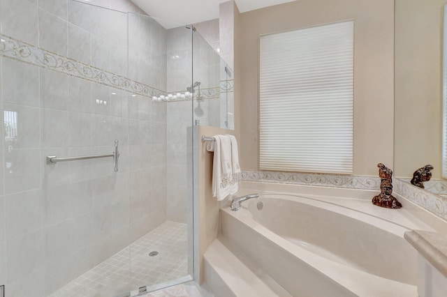 bathroom featuring separate shower and tub