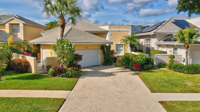 view of front of property with a front yard and a garage