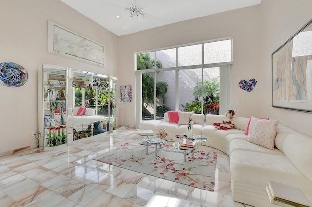 living room featuring a high ceiling and an inviting chandelier